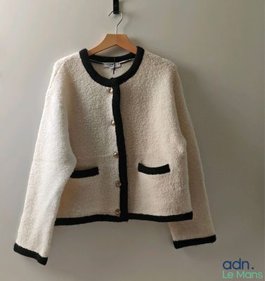 a picture of a white jacket hanging on a hanger
