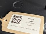 a tag on the back of a frying pan on the stove