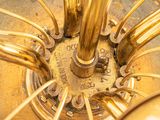 a close up of a golden umbrella with a clock on it