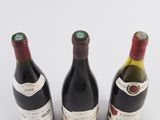 three bottles of wine sitting next to each other on a table