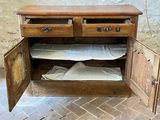 a wooden cabinet with two drawers and a mattress inside