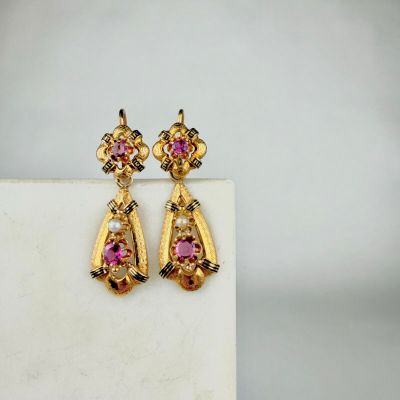 an image of a pair of pink and yellow earrings on a white surface