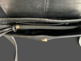 the inside of a black leather purse with a gold clasp