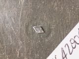 a piece of paper that has a small diamond on it