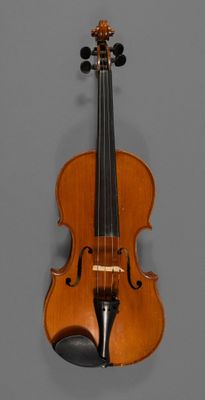 an old violin with a bow hanging on a wall