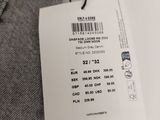 the label on the back of a pair of grey jeans