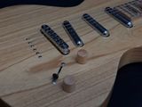 a close up of a guitar that is on a table