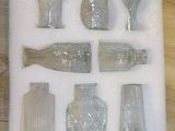 many different glass items in a box on the table