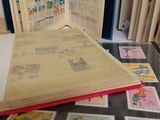 an open book sitting on top of a table with stamps on it