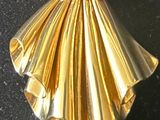 a gold brooch on a black surface