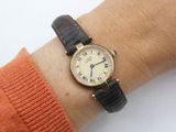 a woman that is wearing a watch on her wrist