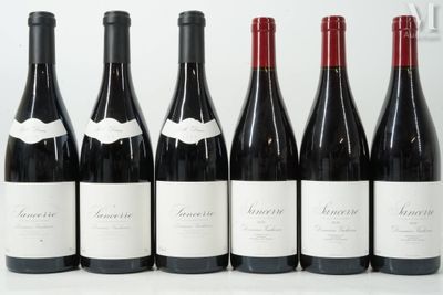 six bottles of wine are lined up in a row on a table