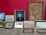 many framed pictures on the floor of this room