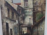 une photo d'un tableau représentant une rue, dans un cadre