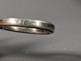 a close up of a silver ring with a diamond on it