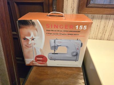 a box with a sewing machine in it on a table