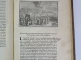 an open book with a picture of a group of people standing in front of a mountain