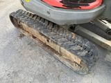 a close up of a tractor with tracks on the ground