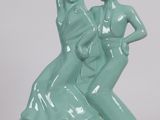 a statue of a man and a woman on a rock
