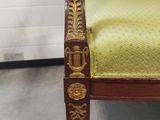 an image of a gold and green chair in a room