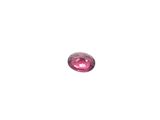 a close up of a pink diamond on a white surface