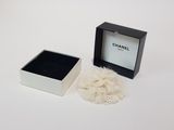 a box with a ring inside of it on a white surface