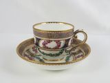 tea cup and saucer decorated with flowers on a white background