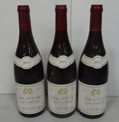 three bottles of wine are lined up on a counter
