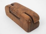 an old wooden stapler with a wooden handle on a white surface