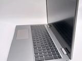 a silver laptop computer sitting on top of a white table