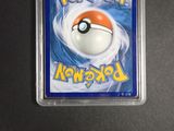 pokemon trading card with a poke ball inside of it on a table