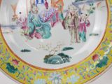 a plate with a painting on it on a table