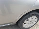 a close up of a car ' s tire on a gravel road