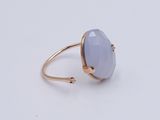 a gold ring with a blue chalceine stone on it