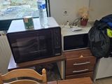 a microwave and a microwave oven in a small kitchen