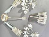 several forks and spoons are arranged in a circle on a table