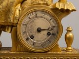 a gold clock that is sitting on top of a table