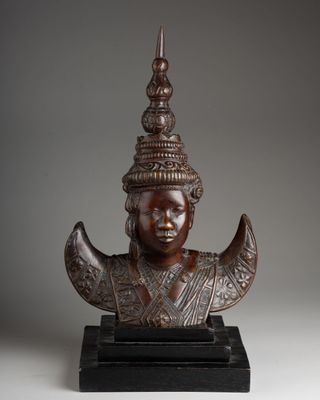 a bronze statue of a woman with a crown on her head