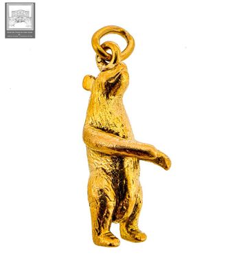 a gold statue of a bear holding a basketball ball