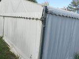 a white tent that has been set up in the grass