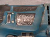 a close up of a blue electric tool on a table