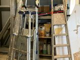 several ladders are stacked on top of each other in a room