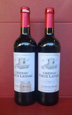 two bottles of wine sitting on top of a table next to each other