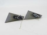 two pieces of metal on a white surface with a pair of scissors
