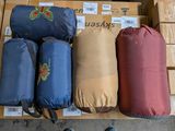 several bags of luggage are stacked on top of boxes in a warehouse