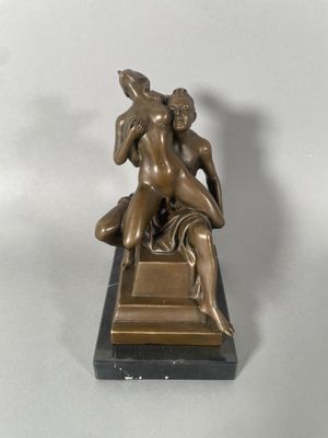 bronze statue of a man and a woman sitting on a marble base