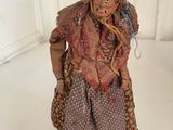 a figurine of a woman in a dress on a skateboard
