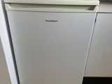 a small white dishwasher in a small kitchen