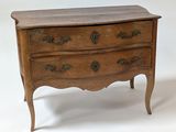 a small wooden chest of drawers on a white background