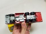 a person holding a toy car in their hand